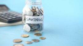 Seorang pemilik usaha kecil sedang memeriksa catatan keuangan, menunjukkan pentingnya pencatatan transaksi yang rapi untuk memantau kesehatan finansial bisnis. Manajemen keuangan yang baik adalah kunci utama bagi keberlanjutan dan pertumbuhan UMKM.